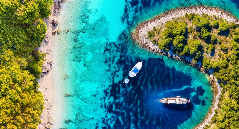 Yachts on the water surface from top view. Turquoise water panor Yachts on the water surface from top view. Turquoise water panor
